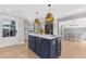Stylish kitchen with a blue island, modern appliances, and access to the dining area at 4304 Lake Laurel Se Dr, Smyrna, GA 30082