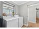 Functional laundry room with side-by-side washer and dryer and natural light at 4304 Lake Laurel Se Dr, Smyrna, GA 30082