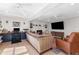 Open-concept living room with a fireplace, a large TV, and natural light at 4304 Lake Laurel Se Dr, Smyrna, GA 30082