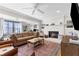 Cozy living room with a fireplace, ceiling fan, and lots of natural light at 4304 Lake Laurel Se Dr, Smyrna, GA 30082