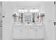 Bright, white double vanity with storage, a large mirror, and marble countertops in a bathroom at 4304 Lake Laurel Se Dr, Smyrna, GA 30082