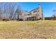 Spacious backyard showcases the home's layout, featuring a deck and landscaped areas at 821 Hood Rd, Fayetteville, GA 30214
