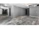 Large open basement space perfect for customization, featuring gray walls and neutral flooring at 821 Hood Rd, Fayetteville, GA 30214