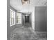 A Basement hallway with multiple recessed lights, gray walls and neutral flooring at 821 Hood Rd, Fayetteville, GA 30214
