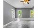The basement features gray walls, neutral flooring and three windows offering plenty of light at 821 Hood Rd, Fayetteville, GA 30214