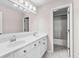 Bathroom with double vanity, large mirror, updated fixtures, and a door leading to the shower at 821 Hood Rd, Fayetteville, GA 30214