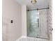 Modern bathroom features a sleek glass shower, updated fixtures, and stylish tile work at 821 Hood Rd, Fayetteville, GA 30214