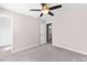 Bedroom featuring neutral walls, carpet, ceiling fan, and an open doorway at 821 Hood Rd, Fayetteville, GA 30214