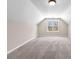 Bright bonus room featuring neutral paint, gray carpet, and a window providing natural light at 821 Hood Rd, Fayetteville, GA 30214