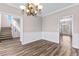 Open dining room featuring wood flooring and access to other living spaces at 821 Hood Rd, Fayetteville, GA 30214