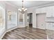 Bright dining area with hardwood floors, a chandelier, and a bay window overlooking the backyard at 821 Hood Rd, Fayetteville, GA 30214