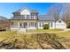 Charming two-story home with a welcoming front porch and a detached two-car garage at 821 Hood Rd, Fayetteville, GA 30214