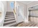 The foyer features hardwood floors, a staircase, and a front door with a view into the living room at 821 Hood Rd, Fayetteville, GA 30214