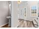 Bright foyer with a half bathroom, wood flooring, and a view into the home at 821 Hood Rd, Fayetteville, GA 30214