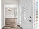 Inviting foyer with wood floors, view to dining room, and decorative front door at 821 Hood Rd, Fayetteville, GA 30214