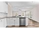 Bright kitchen with hardwood floors, granite countertops, and stainless steel appliances; open to the living room at 821 Hood Rd, Fayetteville, GA 30214