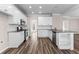 Modern kitchen with white cabinets, stainless steel appliances, granite countertops, and hardwood floors at 821 Hood Rd, Fayetteville, GA 30214