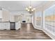 Bright and spacious living area with hardwood floors, a fireplace, and large windows overlooking the backyard at 821 Hood Rd, Fayetteville, GA 30214