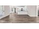 Open concept living and kitchen area with hardwood floors, granite countertops, and stainless steel appliances at 821 Hood Rd, Fayetteville, GA 30214