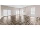A spacious living room with hardwood floors, neutral walls, and glass patio doors to let in lots of light at 821 Hood Rd, Fayetteville, GA 30214