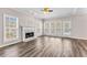 Spacious living room featuring wood flooring, fireplace, and ample natural light at 821 Hood Rd, Fayetteville, GA 30214