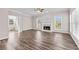 Bright living room with hardwood floors, large windows, and a fireplace with white mantel and marble surround at 821 Hood Rd, Fayetteville, GA 30214
