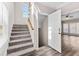 Carpeted stairs lead to a landing with an open door that reveals a sun-filled room at 821 Hood Rd, Fayetteville, GA 30214