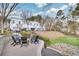 Paver patio in backyard with a firepit, outdoor seating, and lush landscaping at 212 Sessions St, Woodstock, GA 30188