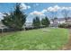 Landscaped backyard featuring a table with chairs, lush green grass, and trees at 212 Sessions St, Woodstock, GA 30188