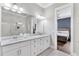 Primary bathroom with white marble countertops, cabinets, and a glass shower at 212 Sessions St, Woodstock, GA 30188