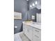 Bathroom with long vanity, white marble countertop and framed mirror at 212 Sessions St, Woodstock, GA 30188
