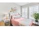 Bright bedroom with hardwood floors, natural light and decor at 212 Sessions St, Woodstock, GA 30188