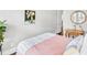 Bedroom features hardwood flooring, bright natural light and modern art at 212 Sessions St, Woodstock, GA 30188