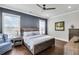 Beautiful bedroom with dark accent wall, ceiling fan and hardwood flooring at 212 Sessions St, Woodstock, GA 30188