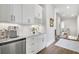Butler pantry with a sink, white cabinets, and views of the stairs leading to a second floor at 212 Sessions St, Woodstock, GA 30188