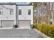 Side view of contemporary townhome with attached garage and manicured landscaping at 212 Sessions St, Woodstock, GA 30188