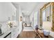 Hallway with long view features modern white cabinetry, marble countertop and beautiful decor at 212 Sessions St, Woodstock, GA 30188