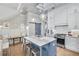 Bright eat-in kitchen with marble countertops, a barn door, an island, and stainless steel appliances at 212 Sessions St, Woodstock, GA 30188
