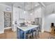 Kitchen featuring an island with marble countertops, stainless steel appliances, and white cabinets at 212 Sessions St, Woodstock, GA 30188
