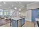 Open concept living space featuring an island with marble countertops and stairs leading to a second floor at 212 Sessions St, Woodstock, GA 30188