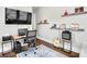 Bright home office featuring wood floors, guitar, floating shelves and music albums at 212 Sessions St, Woodstock, GA 30188