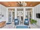 Stylish covered patio with wood ceiling, fan, comfortable seating, and an outdoor living space at 212 Sessions St, Woodstock, GA 30188
