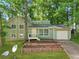 Charming split-level home with a well-maintained lawn, attached garage, and inviting front porch at 5248 Martins Crossing Rd, Stone Mountain, GA 30088