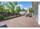 A view of a back deck with a table and chairs, and a view of the backyard and playground set at 5327 David Cir, Covington, GA 30014