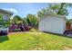 A backyard featuring a shed, swing set, and patio with fire pit at 5327 David Cir, Covington, GA 30014