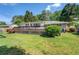 Spacious backyard featuring a large wooden deck, lush greenery, and shaded areas at 5327 David Cir, Covington, GA 30014