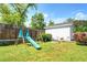 View of a backyard area featuring a swing set with slide, patio, white shed, and a manicured yard at 5327 David Cir, Covington, GA 30014