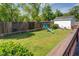 A backyard with a playground set, a fire pit, and a white shed at 5327 David Cir, Covington, GA 30014