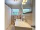 Bathroom with a window, tiled walls, and white counter at 5327 David Cir, Covington, GA 30014