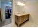 Modern bathroom features a double sink vanity, a large mirror, and a view into the walk-in closet at 5327 David Cir, Covington, GA 30014